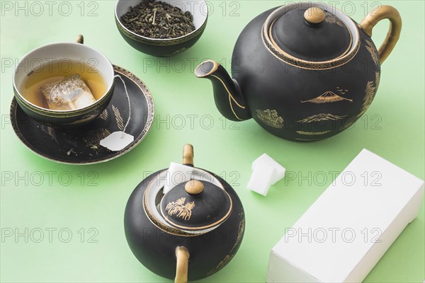 Herbal tea set with white box green paper background