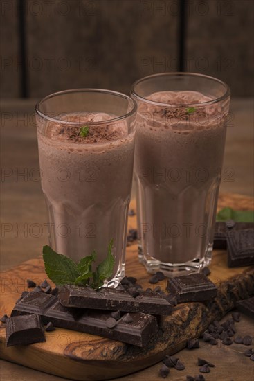 High angle two milkshake glasses with chocolate mint