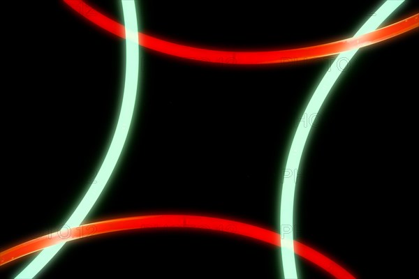 Illuminated red green curve lights black background