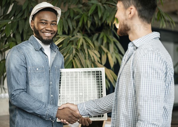 Men shaking hands medium shot