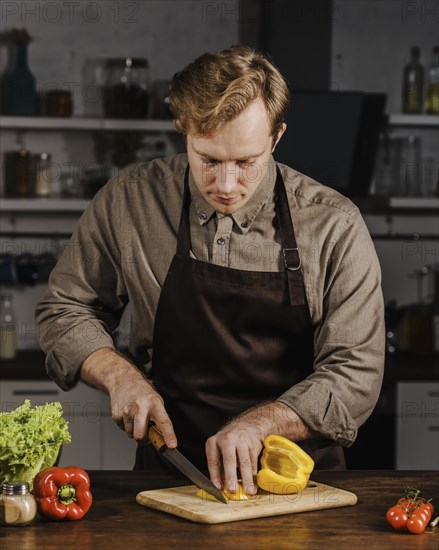 Mid shot chef slicing bell peppers