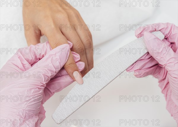 Nail hygiene care beautician wearing gloves close up