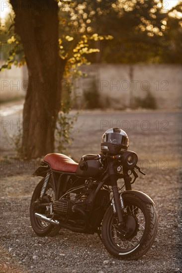 Old motorcycle with helmet outdoors