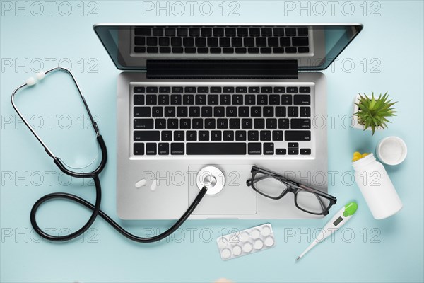 Overhead view healthcare desk with laptop succulent plant