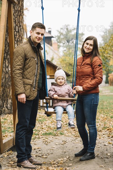 Parents with daughter playground