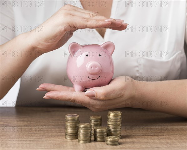 Piggy bank with piles coins