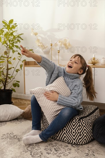 Portrait little girl home pointing