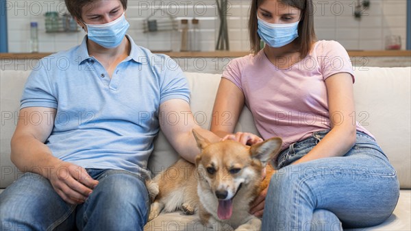 Portrait parents petting family dog