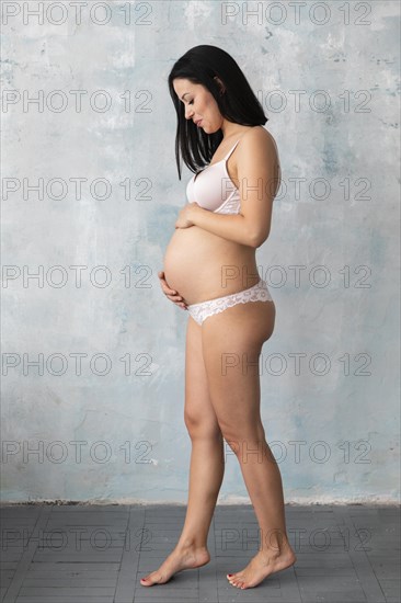 Pregnant woman posing underwear