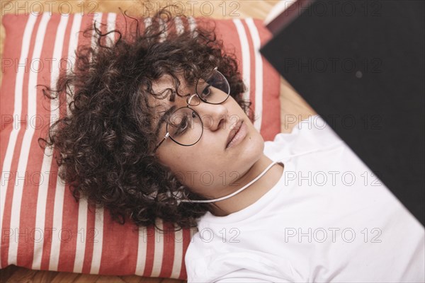 Pretty teenager listening music reading book