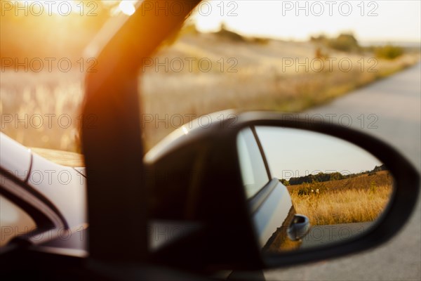 Rearview mirror sunset background