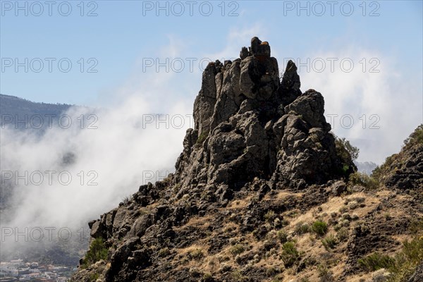 Rocky peak surrounded by clouds
