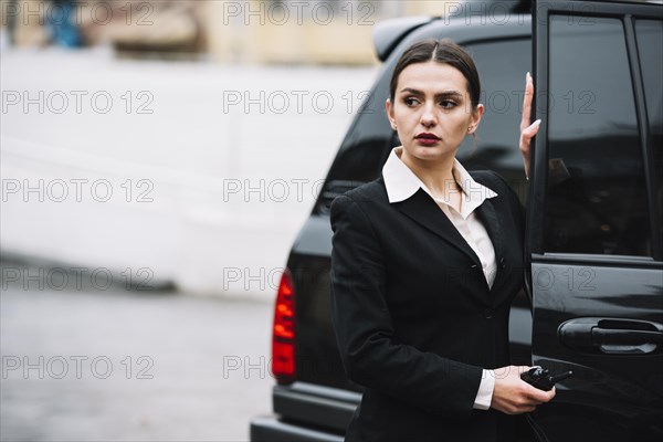 Security woman opening car clientt