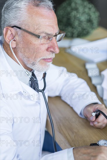 Serious doctor measuring blood pressure