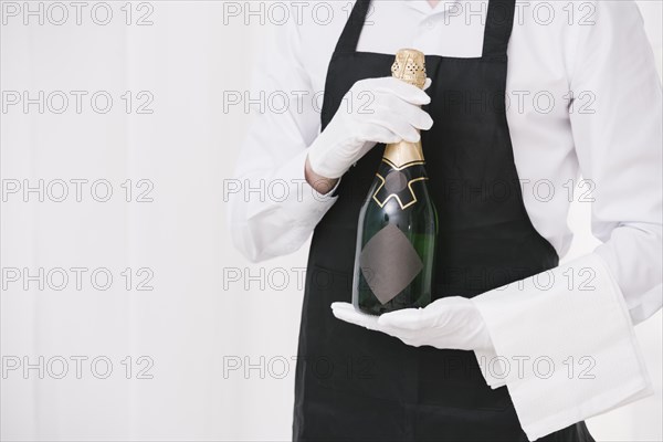 Server holding bottle champagne