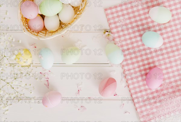 Set easter eggs flower petals near napkin basket
