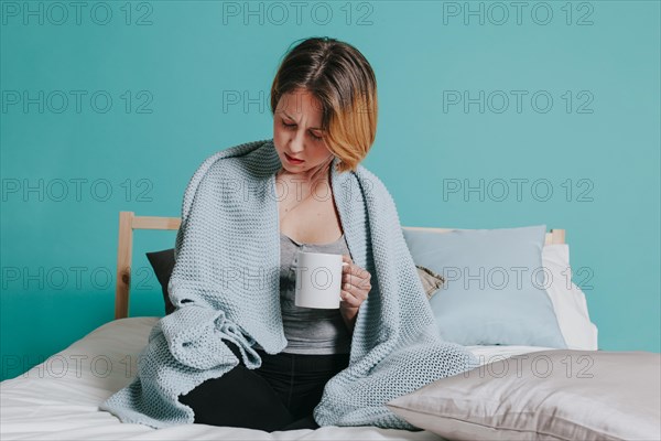 Sick woman with cup bed