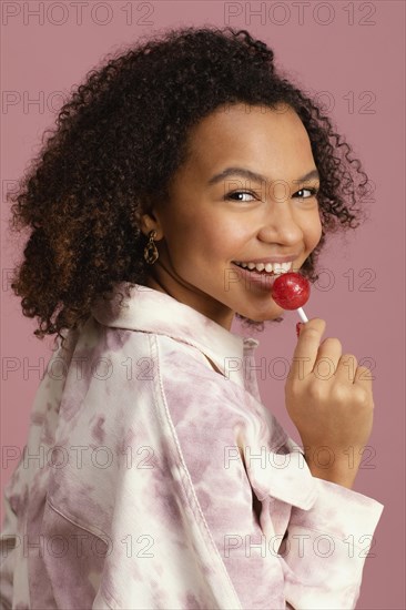 Side view smiley woman with lollipop