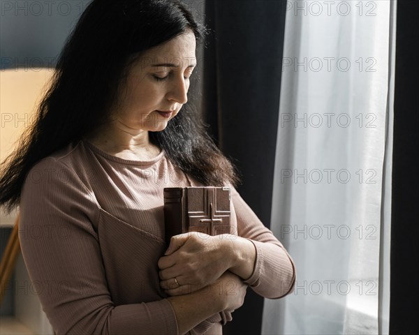 Side view woman holding holy book