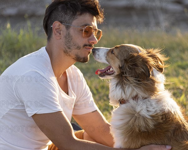 Side view young man with dog seaside