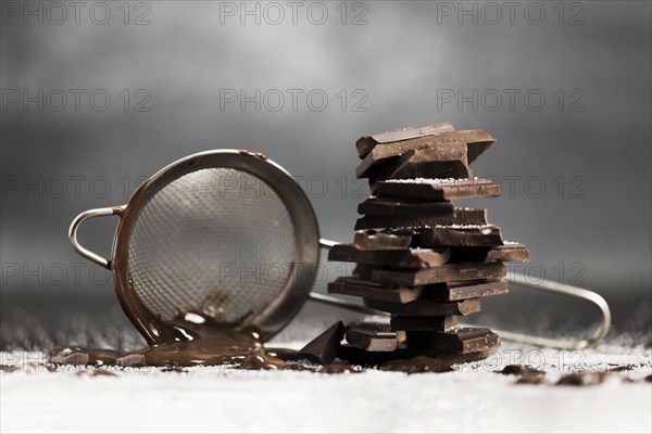 Sieve with melted chocolate sugar