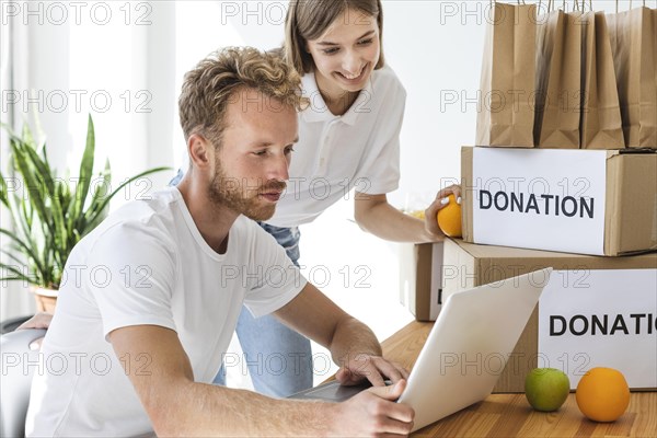 Smiley volunteers using laptop