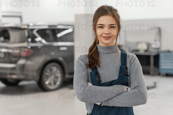 Smiley woman working car service