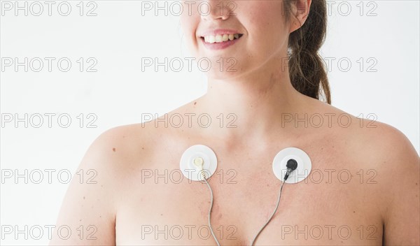 Smiling female with electrodes body