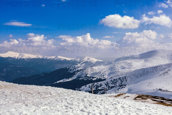 Snowy mountain landscape against blue sky