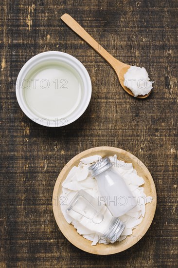 Spoonfull with bowls coconut oil top view