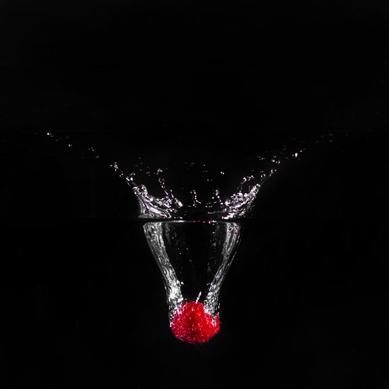 Strawberry plunging into water