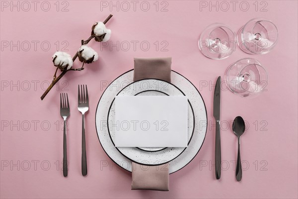 Table etiquette with pink background flat lay