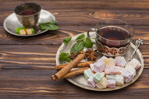 Tea cup with turkish delight wooden table