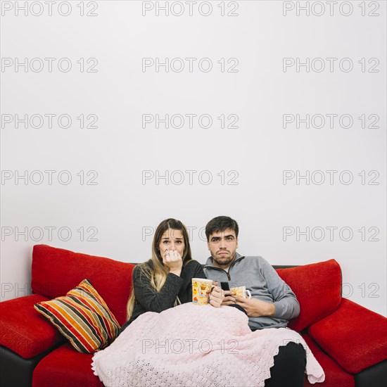 Terrified couple watching movie