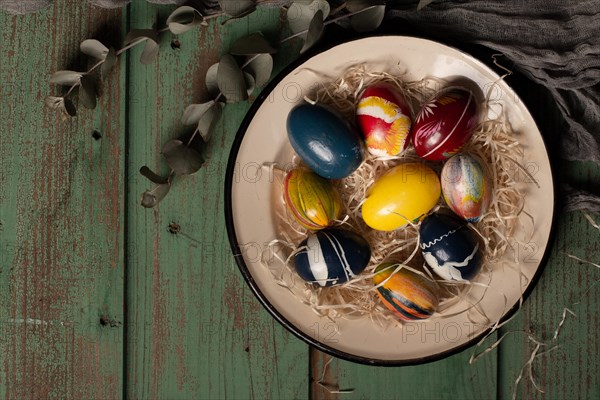 Top view colorful easter eggs plate