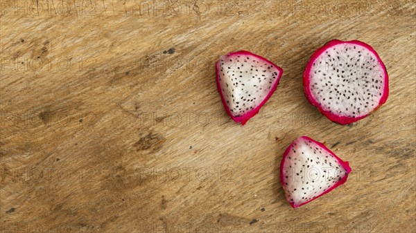 Top view dragon fruit with wooden background