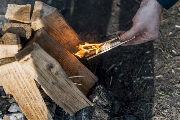 Top view man making bonfire