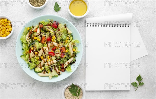 Top view pasta salad with balsamic vinegar blank notebook