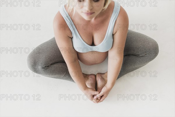 Top view pregnant woman meditating