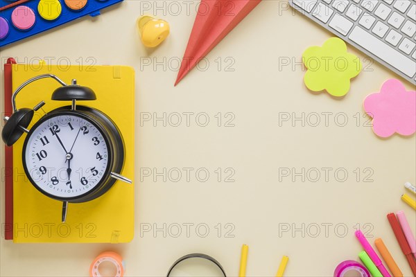 Top view school supplies alarm clock