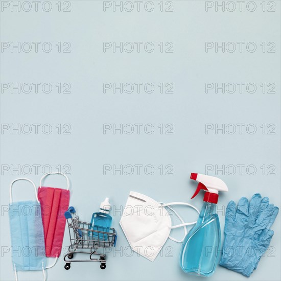 Top view small shopping cart with medical masks copy space