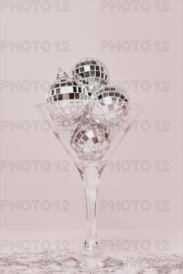 Transparent champagne glass with silver balls