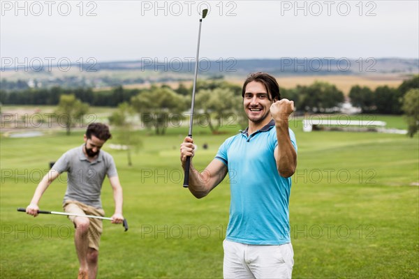 Two men having fun golf course