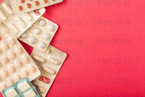 Various pills blister pack red background