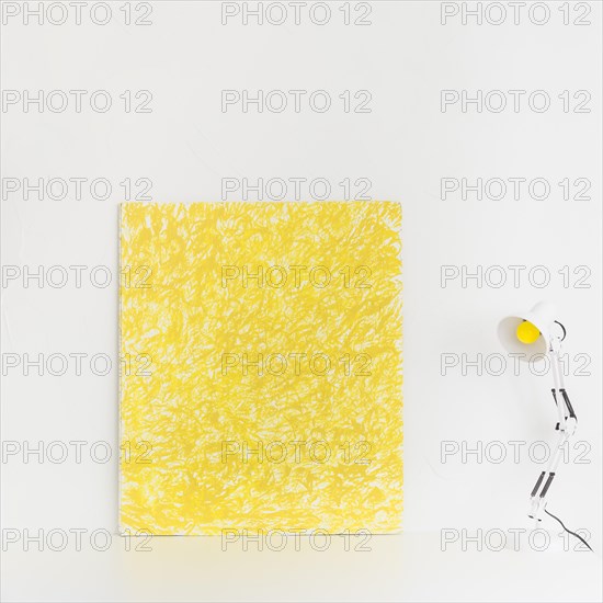 White workspace with yellow picture reading lamp