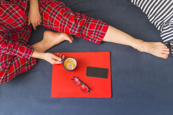 Woman bed with coffee smartphone