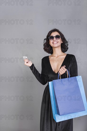 Woman black with bright shopping bags credit card