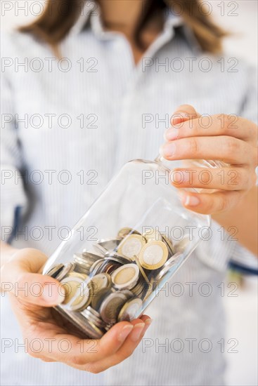 Woman holding jar with money