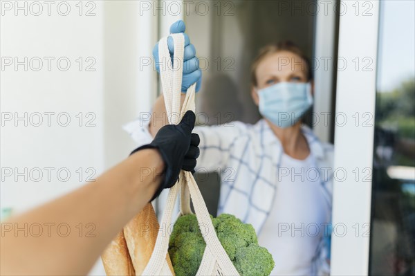 Woman home picking up her groceries self isolation