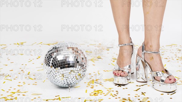 Woman legs high heels disco ball